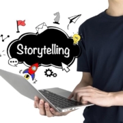 Person using a laptop with creative icons and the word "Storytelling" displayed, representing how managed IT services in New York support immersive digital content creation and seamless storytelling experiences.