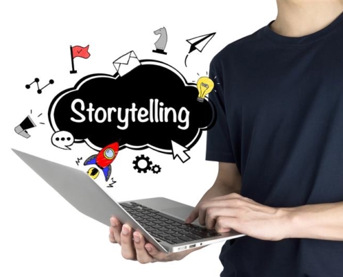 Person using a laptop with creative icons and the word "Storytelling" displayed, representing how managed IT services in New York support immersive digital content creation and seamless storytelling experiences.